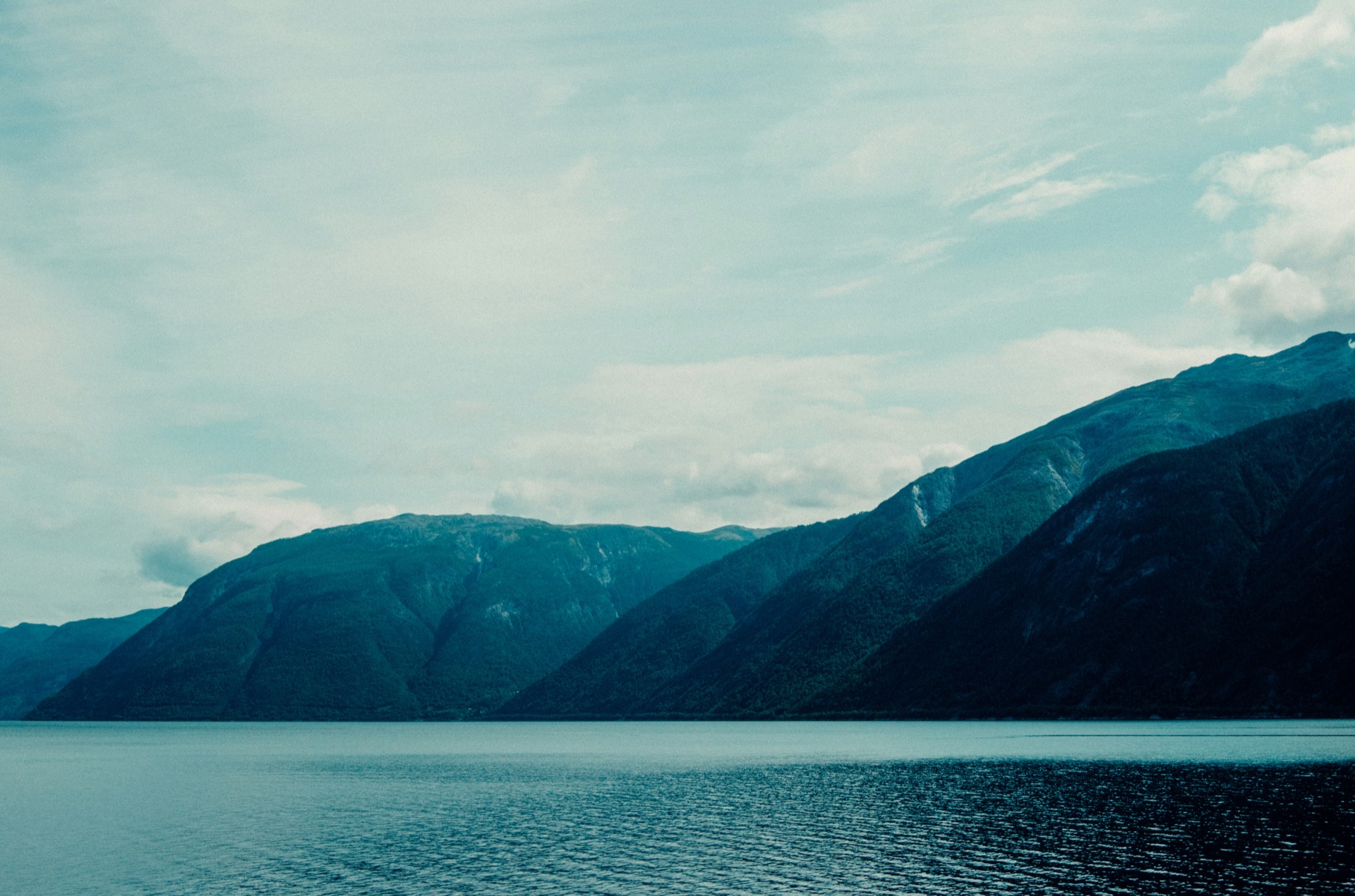 Moody Sognefjord landscape — mountains rising steeply from calm fjord water